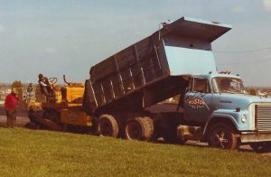 Ruston Paving installing asphalt with International dump truck and blaw knox paver