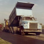 Ruston Paving installing asphalt with International dump truck and blaw knox paver