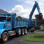 Ruston Paving removing asphalt with an excavator at Thomas Creek in Perinton